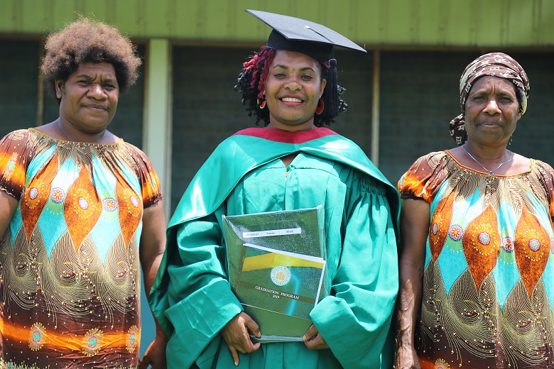 Scholarship recipient standing with 2 women