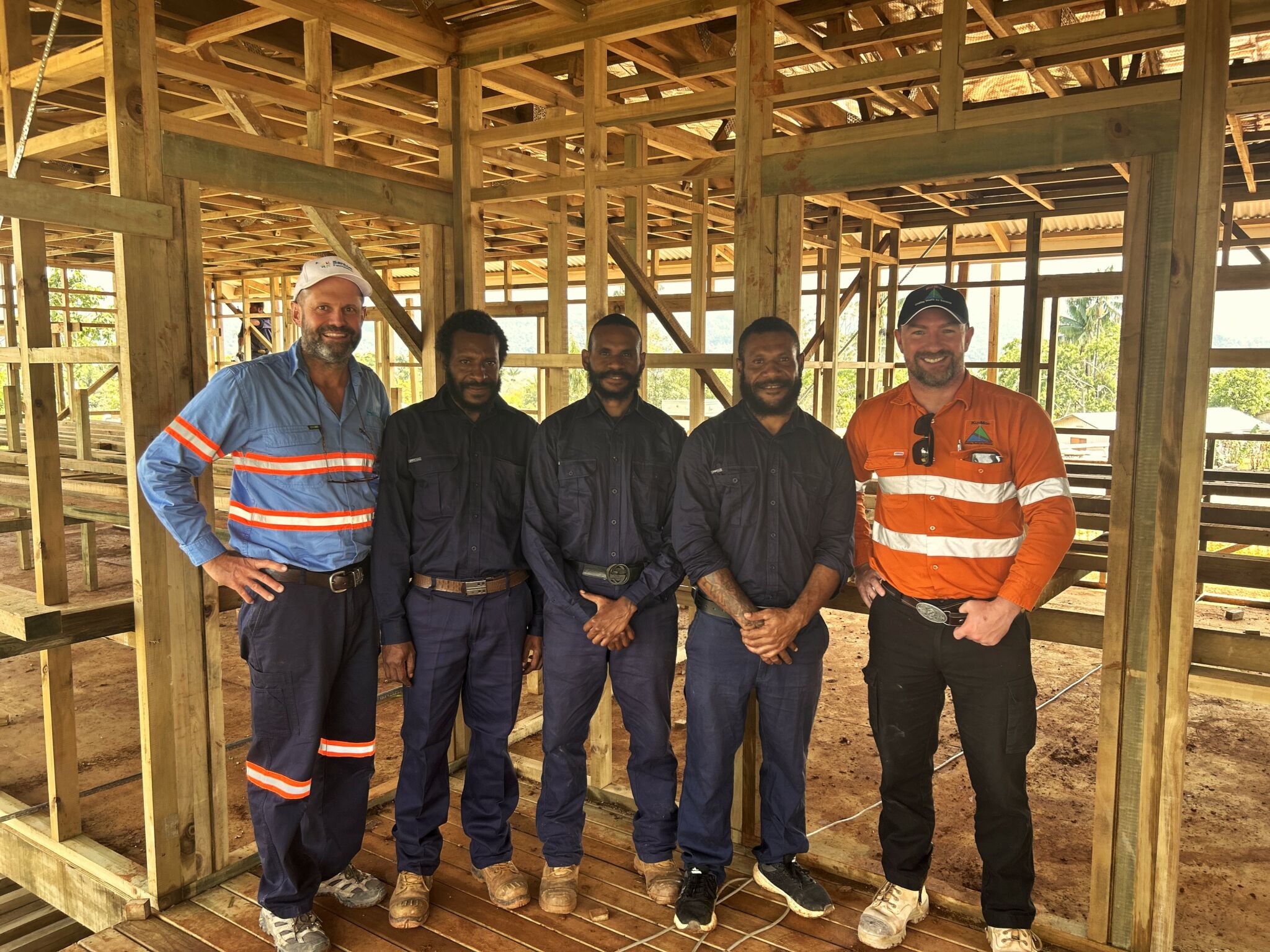 Pigma teachers in tradesmen uniforms posing for the picture