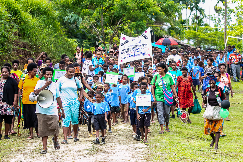 Students, teachers accompanied by parents marching around Kikori to raise awareness of Children’s Rights during the Universal Children’s Day.